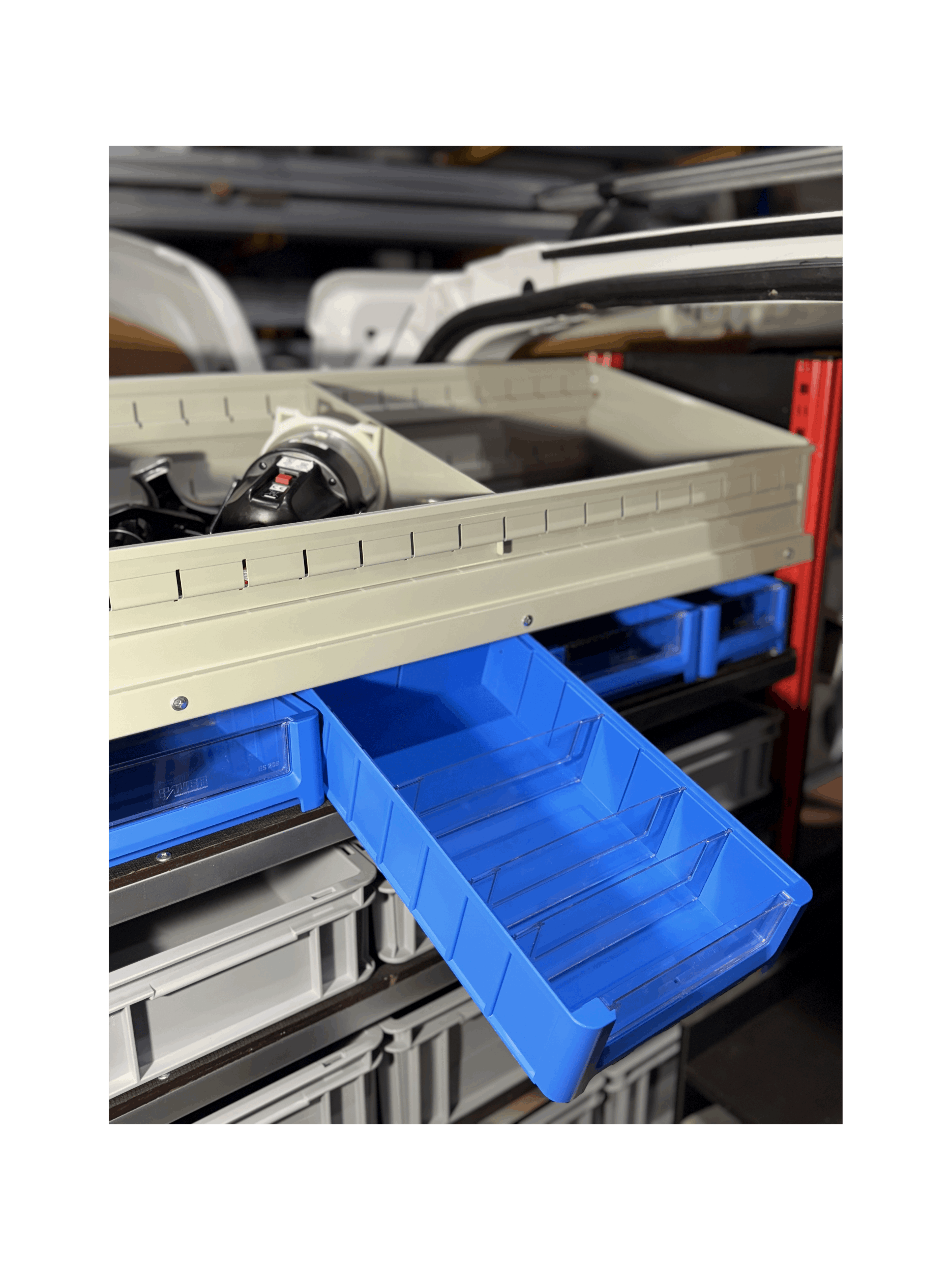 A Blue Shelf Bin being Displayed on a Pull Out Shelving Unit in a Van