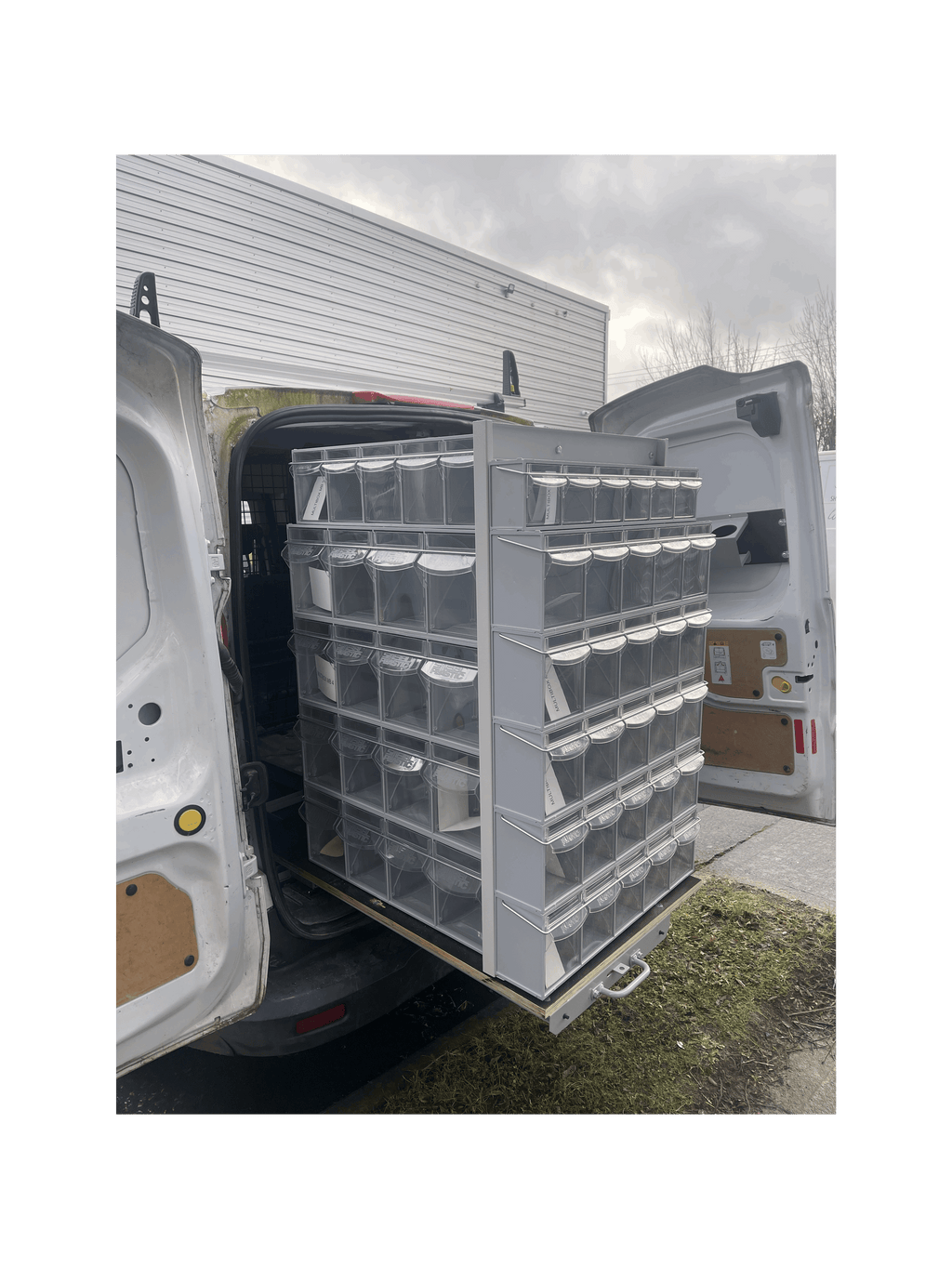 Stacks of MB Boxes on the Back of a Pull Out Shelving Unit in a Van