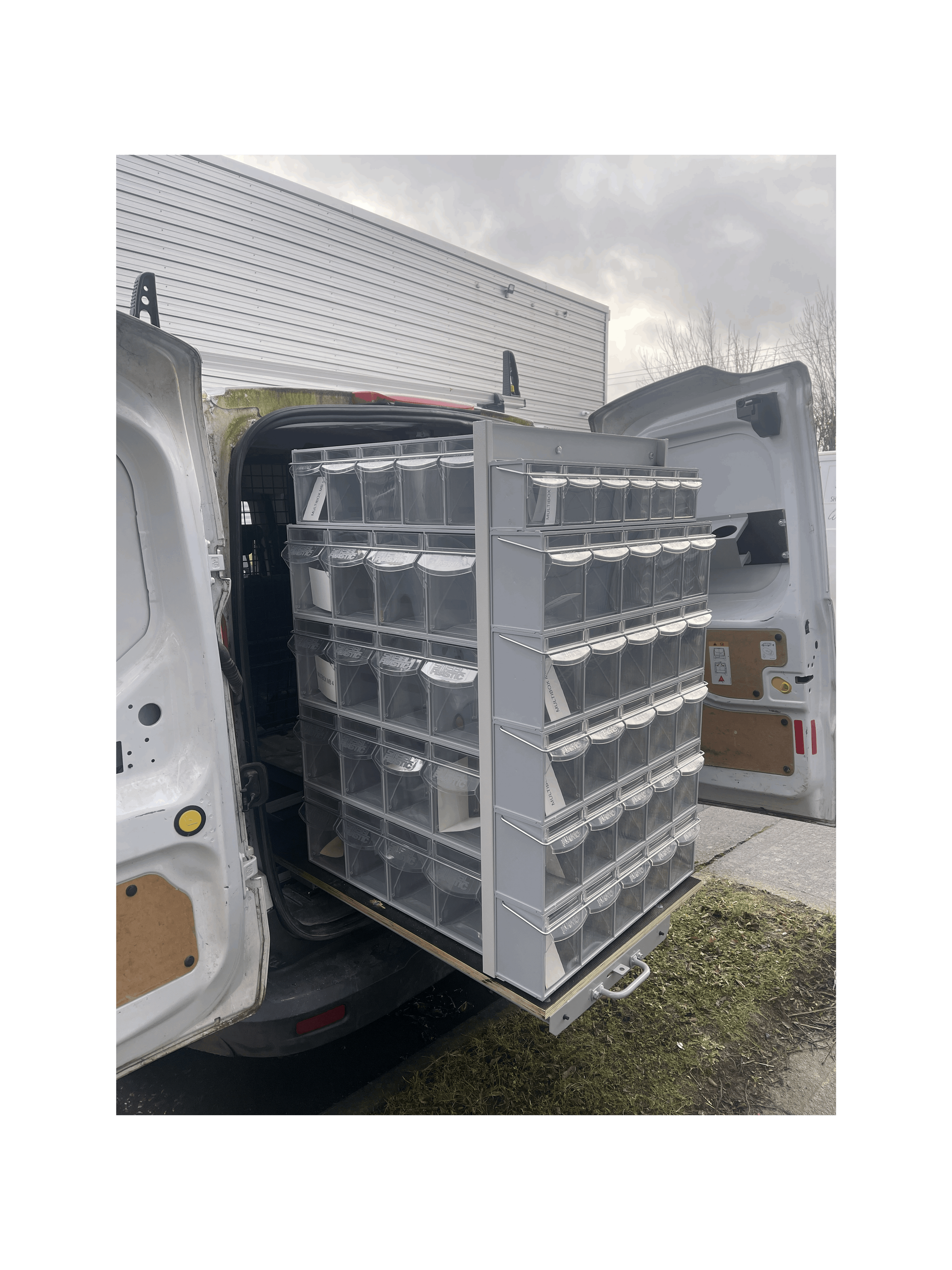 Stacks of MB Boxes on the Back of a Pull Out Shelving Unit in a Van