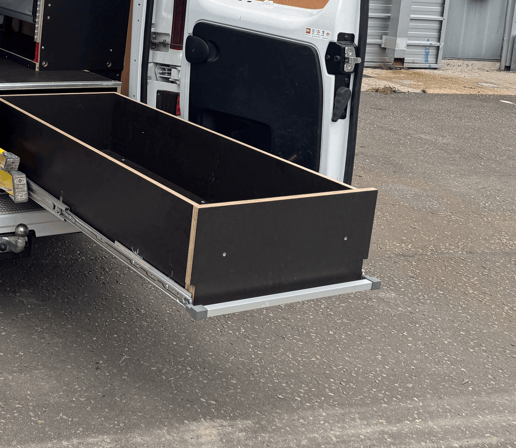 A False Floor Drawer Opened out from the Back Door of a Van